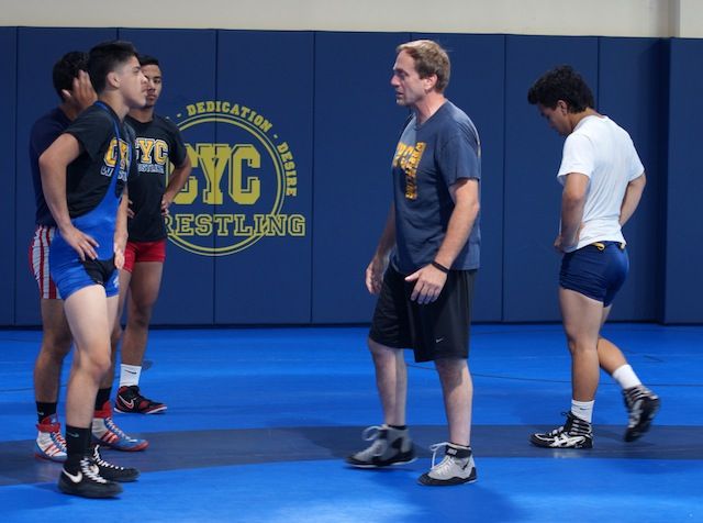 CYC coach Mark Halvorson, right, offers pointers during a late-June workout.