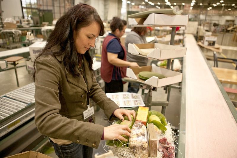 Packing a basket on the factory line with Lupe